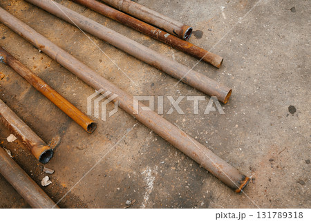 Rusty Steel Pipes on Concrete Surface Layout Rusty Steel Pipes on Concrete Surface Layout 131789318