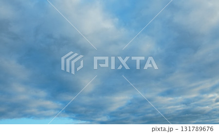 A breathtakingly beautiful sky adorned with soft, fluffy clouds set against a deep blue background A breathtakingly beautiful sky adorned with soft, fluffy clouds set against a deep blue background 131789676