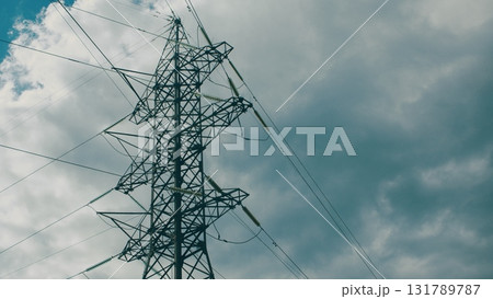 High Tension Power Lines Stand Against a Dramatic Sky, Emphasizing Connectivity and Energy 131789787