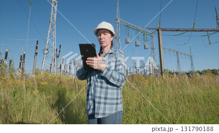Professional Engineer in Power Field Using Tablet for Data Analysis and Monitoring Professional Engineer in Power Field Using Tablet for Data Analysis and Monitoring 131790188