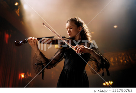 girl playing violin on stage girl playing violin on stage 131790762