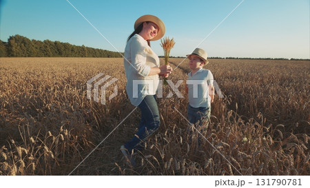 A loving Mother and her Child are Joyfully Enjoying the Beauty of Nature in a Vibrant Field A loving Mother and her Child are Joyfully Enjoying the Beauty of Nature in a Vibrant Field 131790781