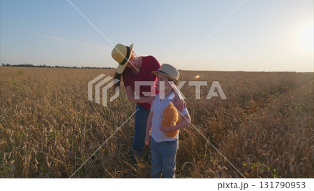 A Child and an Adult are Happily Enjoying a Beautiful Day in the Open Field Together A Child and an Adult are Happily Enjoying a Beautiful Day in the Open Field Together 131790953