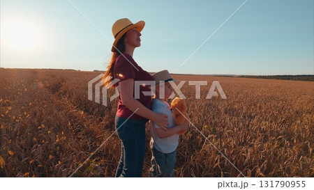 A Mother and Her Child are Enjoying a Beautiful and Joyful Day in a Vibrant Field 131790955