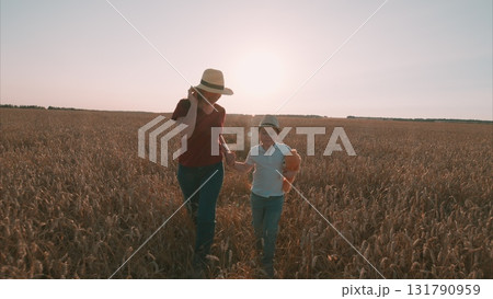 Enjoying Beautiful and Joyful Moments in the Expansive Wheat Field Alongside a Child Enjoying Beautiful and Joyful Moments in the Expansive Wheat Field Alongside a Child 131790959