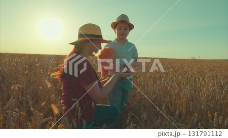 A Loving Mother and Her Child Enjoying a Beautiful Day Together in the Wheat Field 131791112