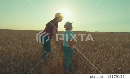 A Heartwarming Scene of a Mother and Her Child Having a Wonderful Day in the Wheat Field 131791354