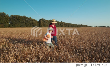Joyful Moments in a Wheat Field A Cherished Child and Their Guardian Exploring Nature Together Joyful Moments in a Wheat Field A Cherished Child and Their Guardian Exploring Nature Together 131791426