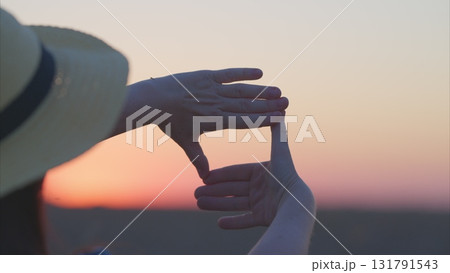 Framing Nature Capturing the Hands Creating a Visual Portal During a Stunning Sunset Framing Nature Capturing the Hands Creating a Visual Portal During a Stunning Sunset 131791543