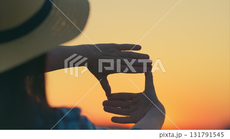 Framing Nature Showcasing Beautiful Hands Skillfully Capturing the Stunning Beauty of a Sunset Framing Nature Showcasing Beautiful Hands Skillfully Capturing the Stunning Beauty of a Sunset 131791545