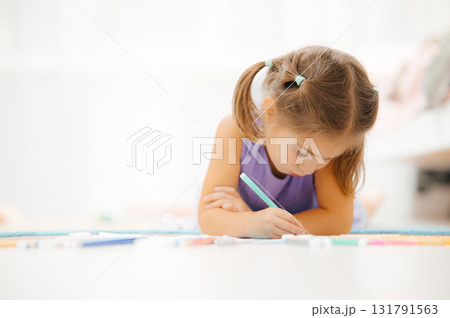 A Young Girl Fully Engaged in a Creative and Fun Drawing Activity That Sparks Her Imagination A Young Girl Fully Engaged in a Creative and Fun Drawing Activity That Sparks Her Imagination 131791563