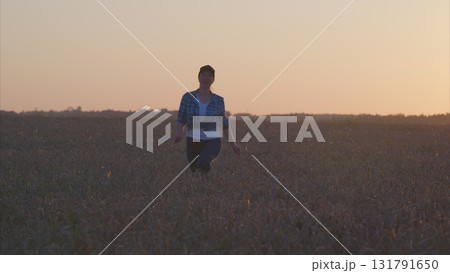 A Joyful Moment in a Beautiful Golden Field at Sunset, Capturing Happiness and Freedom 131791650