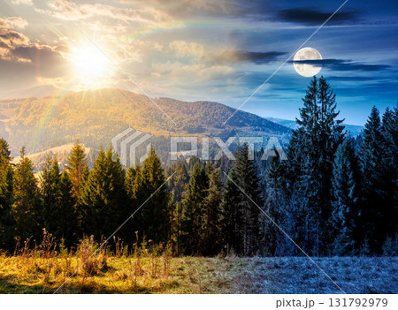 landscape with coniferous forest behind the meadow on autumn equinox. day and night time change concept. nature background with blue sky and mountain ridge with sun and moon. alpine woodland landscape with coniferous forest behind the meadow on autumn equinox. day and night time change concept. nature background with blue sky and mountain ridge with sun and moon. alpine woodland 131792979