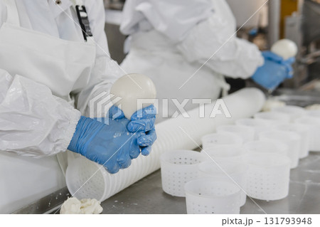 Mozzarella cheese factory. Produces handmade mozzarella with fresh milk, close up Mozzarella cheese factory. Produces handmade mozzarella with fresh milk, close up 131793948