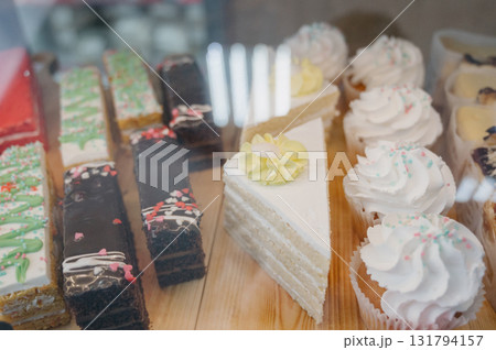 A sweet display case with confectionery and creamy cupcakes A sweet display case with confectionery and creamy cupcakes 131794157