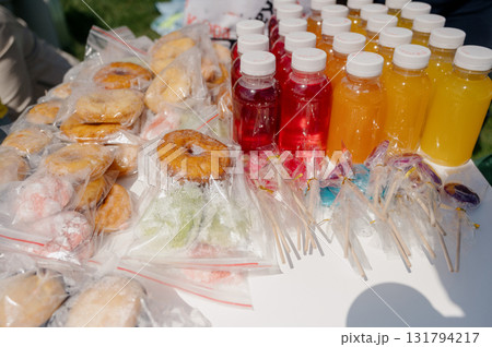 Colorful drinks, donuts, and candies for a children's party at the fair 131794217