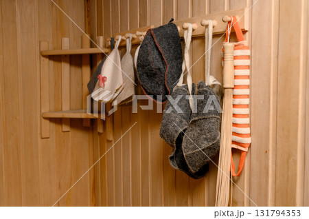 The interior of a classic steam room finished in light wood with a corner bench. 131794353