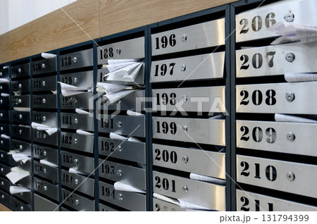 Modern mailboxes for residents of an apartment building with letters Modern mailboxes for residents of an apartment building with letters 131794399