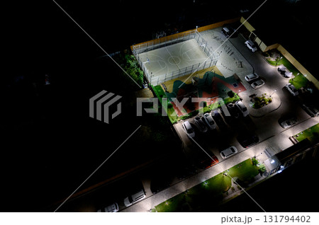 Night view from above of a landscaped courtyard with a basketball court Night view from above of a landscaped courtyard with a basketball court 131794402