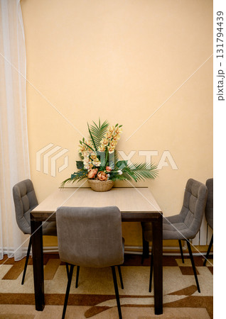 A dining table with four gray chairs A dining table with four gray chairs 131794439