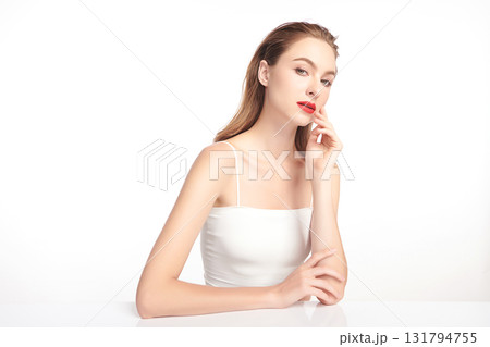 A beautiful young woman with clean, fresh skin against a white background. Skincare, facial treatment, cosmetology, beauty, and spa. An elegant portrait of an woman. A beautiful young woman with clean, fresh skin against a white background. Skincare, facial treatment, cosmetology, beauty, and spa. An elegant portrait of an woman. 131794755