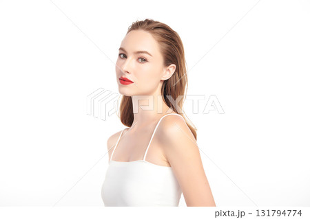 A beautiful young woman with clean, fresh skin against a white background. Skincare, facial treatment, cosmetology, beauty, and spa. An elegant portrait of an woman. 131794774