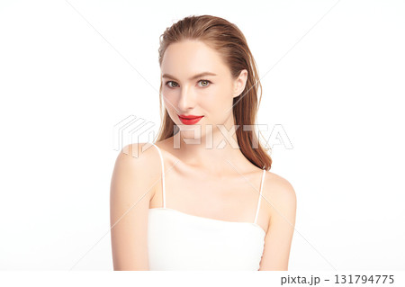 A beautiful young woman with clean, fresh skin against a white background. Skincare, facial treatment, cosmetology, beauty, and spa. An elegant portrait of an woman. 131794775