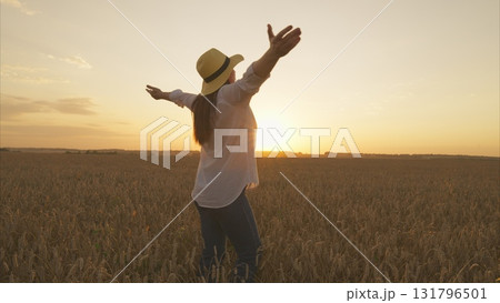 Experience the mesmerizing beauty of a picturesque sunset in a tranquil wheat field Experience the mesmerizing beauty of a picturesque sunset in a tranquil wheat field 131796501