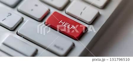 Red help button on white computer keyboard close up 131796510