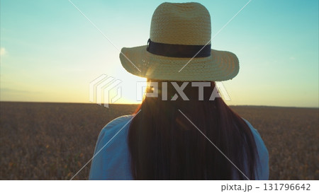 A Serene and Beautiful Sunset View Featuring a Woman Wearing a Stylish Straw Hat A Serene and Beautiful Sunset View Featuring a Woman Wearing a Stylish Straw Hat 131796642