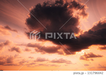 Sunset Cloudy Sky With Fluffy Clouds. Sunset Sky Natural Background. Sunrays In Dramatic Sky. Sunset In Yellow, Orange, Pink Colors 131796842
