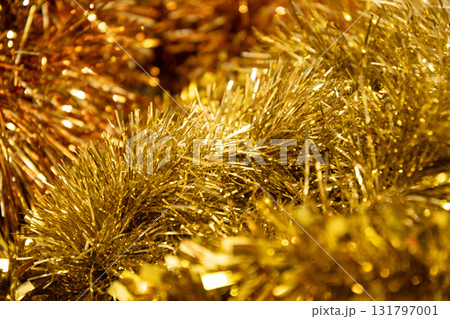 Golden tinsel Christmas tree bokeh background. Festive pattern. Xmas holiday spirit. Golden tinsel Christmas tree bokeh background. Festive pattern. Xmas holiday spirit. 131797001