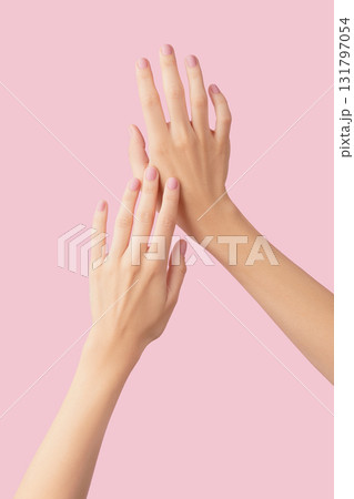 Beautiful groomed womans hands with pink matte nail design on a pink background. Manicure, pedicure beauty salon Beautiful groomed womans hands with pink matte nail design on a pink background. Manicure, pedicure beauty salon 131797054