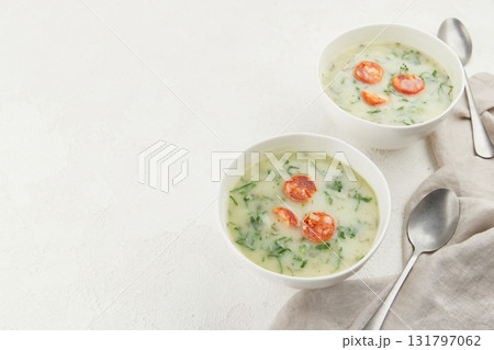 Two bowls of Portuguese style soup Caldo Verde on white background 131797062