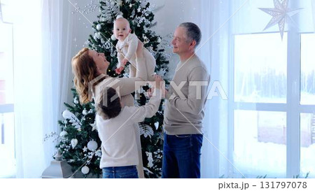 Large family standing with Christmas tree together laugh smiles and funny moments. Standing by Christmas tree big family radiates joy and unity smiles reflecting the strong bonds and love. Large family standing with Christmas tree together laugh smiles and funny moments. Standing by Christmas tree big family radiates joy and unity smiles reflecting the strong bonds and love. 131797078