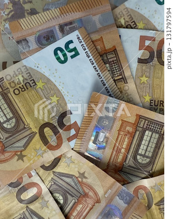 Macro photography of euro currency, highlighting financial themes such as pensions, taxes, income, and losses. Money, economics, and financial literacy. 131797594