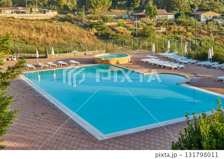Tranquil hillside pool terrace with turquoise water and panoramic countryside view in morning Piana degli Albanesi, Italy 131798011