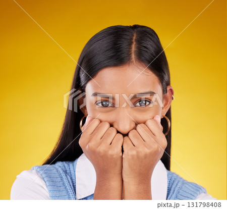 Portrait, wow and excited with a woman on a yellow background in studio looking shocked or in awe. Face, surprise and omg with an attractive young female standing hands over mouth in amazement 131798408