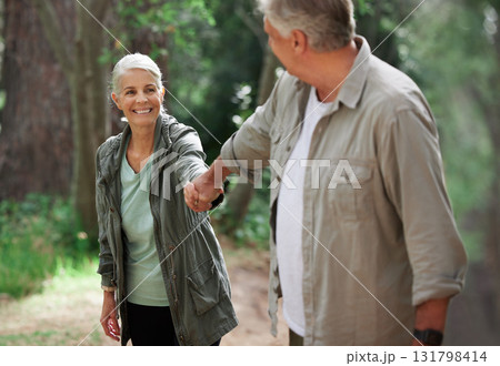 Elderly couple, hiking and holding hands in a forest, happy and relax while walking in nature. Senior, backpacker and woman with man outdoors for travel, freedom and healthy lifestyle in retirement Elderly couple, hiking and holding hands in a forest, happy and relax while walking in nature. Senior, backpacker and woman with man outdoors for travel, freedom and healthy lifestyle in retirement 131798414
