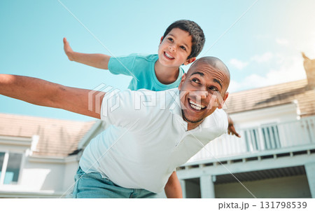 Father and child playing airplane outdoor as family in backyard of house with a smile, love and care. Man and boy kid for game, security and quality time with happiness and arms outstretched on sky Father and child playing airplane outdoor as family in backyard of house with a smile, love and care. Man and boy kid for game, security and quality time with happiness and arms outstretched on sky 131798539