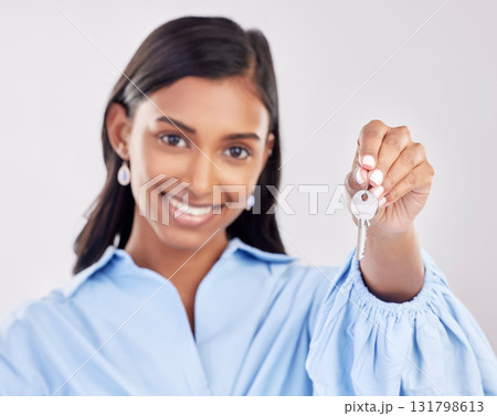 Happy, showing and a portrait of a woman with keys isolated on a white background in a studio. Real estate, smile and a girl holding a key to a house, apartment or property as a new homeowner 131798613