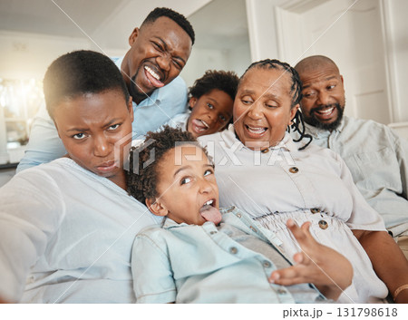 Funny, goofy and selfie of black family make joke with faces in a home or house while on vacation or holiday. Social media, mother and father with children and grandparents happy bonding with humor Funny, goofy and selfie of black family make joke with faces in a home or house while on vacation or holiday. Social media, mother and father with children and grandparents happy bonding with humor 131798618