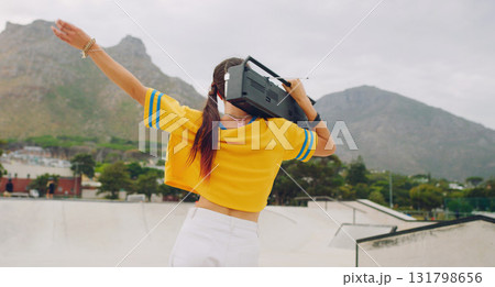 Radio, dance and woman with a boombox in the city listening to music, moving and having fun. Freedom, hip hop and female dancing with energy to a song, album or playlist on a speaker in a urban town. 131798656
