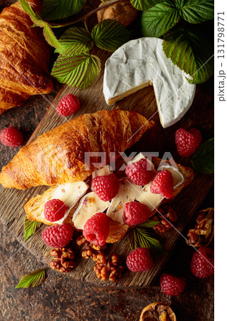 Croissant with camembert cheese, raspberries and walnuts. Croissant with camembert cheese, raspberries and walnuts. 131798771