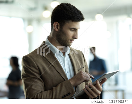 Technology, communication and businessman with tablet reading email, sales report or company website in office. Research, leadership and networking, online schedule management app at startup agency. 131798874