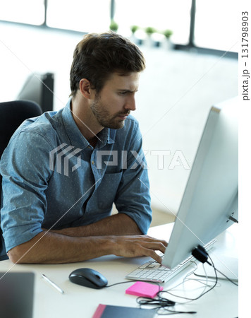 Concentrating, computer and typing with business man in office for web design, analytics and planning. Vision, technology and internet with employee in digital agency for idea, advertising and email 131798903