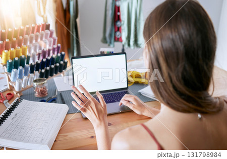 Laptop, planning and schedule with a woman designer working in her office on creative fashion for retail. Computer, calendar and ecommerce with a female seamtress or tailor at work on design 131798984