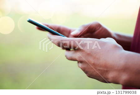 Hands, phone and communication on mockup for social media, texting or chatting in the outdoors. Hand of person typing on smartphone with 5G connection, browsing or mobile app on blurred background 131799038