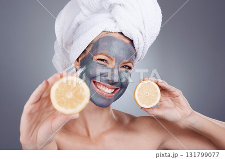 Lemon mask, clay and woman with smile for healthy facial, beauty portrait and wellness makeup in studio. Happy female model, citrus fruits and vitamin c for charcoal product, shower and laughing face 131799077