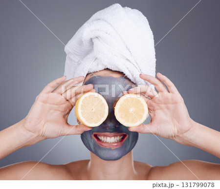 Lemon, face mask and woman cover eyes for healthy skincare, beauty and anti aging wellness makeup in studio. Happy female model, citrus fruits and vitamin c for aesthetic facial, shower glow or smile 131799078